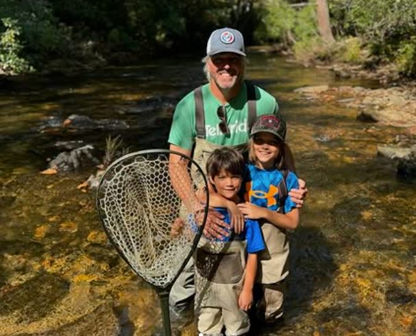 Hunter Morris teaching two young anglers on the stream